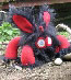 black shaggy fur monster with red fleece