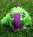 bright green shaggy fur monster with purple spikes (front view)